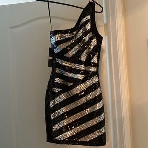 Stunning mini Limited edition dress from Bebe with silverblack sequins all over.